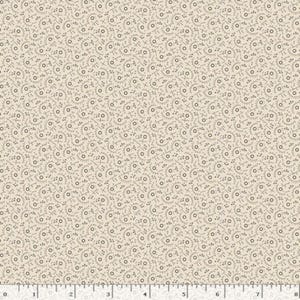 May include: Beige fabric with a repeating pattern of small, dark gray circular and cross-shaped designs. The fabric has a subtle, textured appearance, and a ruler is visible along the bottom edge, indicating measurements in inches.