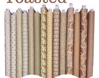 May include: A collection of fabric rolls in various shades of tan, beige, and brown. The rolls display different patterns, including paisley, floral, and geometric designs. The word "Toasted" is printed at the top, and "Jo Morton" is printed at the bottom.