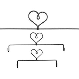 May include: Three-tiered, black metal wall decor with heart-shaped accents. Each tier has a horizontal bar with hooks on each end. The top tier has a large heart at the top, while the other tiers have smaller hearts.