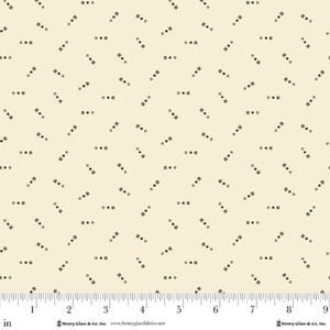May include: Cream-colored fabric with a repeating pattern of small, dark brown squares and dots. The fabric has a ruler along the bottom edge, with measurements in inches. The text "Henry Glass & Co. Inc." and "www.henryglassfabrics.net" are visible.