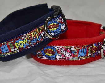 May include: Two dog collars with a comic book theme. One collar is red with a black fleece lining and the other is blue with a navy fleece lining. Both collars feature a colorful ribbon with the words "BAM", "POW", "BOOM", and "BANG" printed on them.