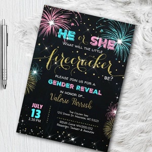 May include: A black gender reveal invitation with pink, blue, and gold accents. The invitation features fireworks, the text "He or She, What will the little firecracker be?" and event details. A silver pen rests on the left.