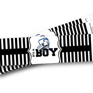 May include: Stacked rectangular labels with a black and white striped pattern. Each label features a white central design with the text "It's a BOY" and a whistle graphic. The labels are for a baby shower.