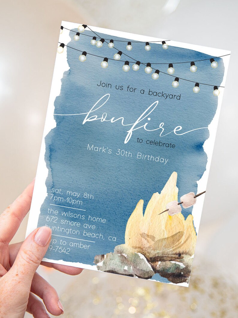 May include: A blue watercolor invitation with string lights and a campfire illustration. The text reads "Join us for a backyard bonfire to celebrate Mark's 30th Birthday". The invitation includes the date, time, and location of the event.