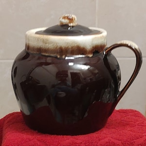 May include: A rustic wooden sign with the text "Welcome to our porch" in white lettering. The sign features a distressed finish and a simple, inviting design, perfect for outdoor decor.