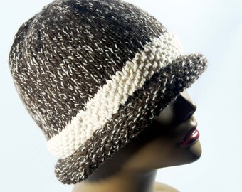May include: A brown and white knit beanie with a wide brim. The beanie has a white stripe around the brim.