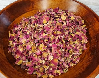 May include: A wooden bowl filled with dried rose petals. The petals are a mix of pink and brown.
