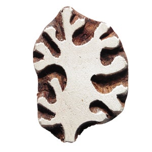 May include: A wooden block printing stamp featuring a white tree design. The stamp is carved with a detailed tree pattern and is ready to be used for textile printing.