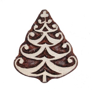 May include: A brown wooden block with a white design of a Christmas tree. The tree has a star at the top and is decorated with simple lines and curves.