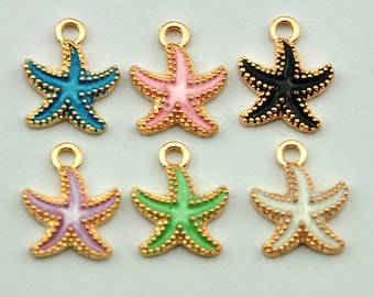 Pode incluir: Seis pingentes de estrela do mar dourados com detalhes em esmalte. As estrelas do mar são de várias cores: azul, rosa, preto, verde, branco e rosa claro.