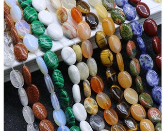May include: Assortment of oval-shaped gemstone beads in various colors, including green, blue, brown, orange, and white. The beads are strung on a clear thread and are ready for jewelry making.