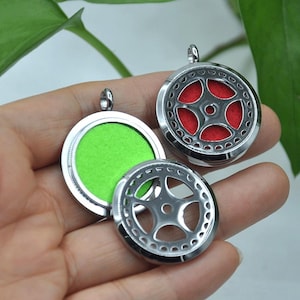 Puede incluir: Tres colgantes de aromaterapia plateados con diseños calados. Un colgante tiene una almohadilla de fieltro verde brillante y otro una almohadilla de fieltro roja. Los colgantes son redondos con un pequeño lazo en la parte superior para una cadena.