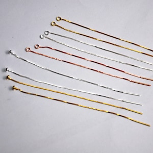 Può includere: Assortimento di estensori per orecchini a catena in argento, oro e oro rosa. Gli estensori sono realizzati con catene delicate e hanno un anello a un'estremità e una perla all'altra.