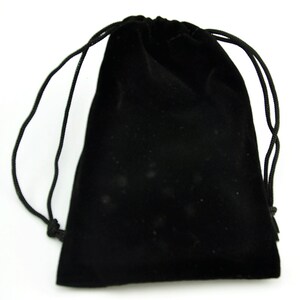 May include: A black velvet drawstring bag with a black cord.