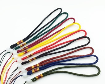 May include: Assortment of colorful, braided cords with gold accents and white beads. The cords are approximately 15 inches long and are perfect for making keychains, lanyards, or other crafts.