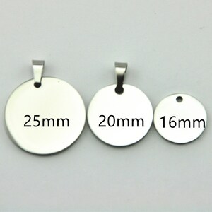 May include: Three silver metal round blank tags with jump rings. The tags are 25mm, 20mm, and 16mm in diameter.