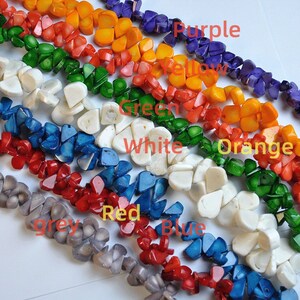 May include: A collection of colorful gemstone beads in shades of purple, yellow, orange, green, white, blue, red, and grey. The image displays the beads in rows, with each row showcasing a different color. Text labels identify each color.