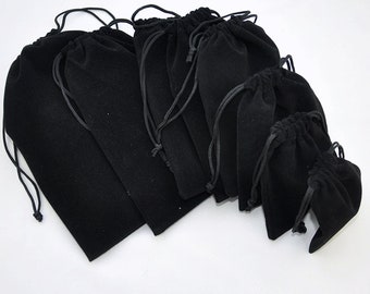 May include: A set of black velvet drawstring pouches of various sizes. The pouches are made of soft, luxurious velvet and are perfect for storing small items like jewelry, gifts, or accessories.