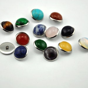 Puede incluir: Surtido de 14 botones redondos de piedras preciosas con engastes plateados. Las piedras preciosas incluyen turquesa, rojo, verde, azul, amarillo, rosa, marrón, negro y blanco.