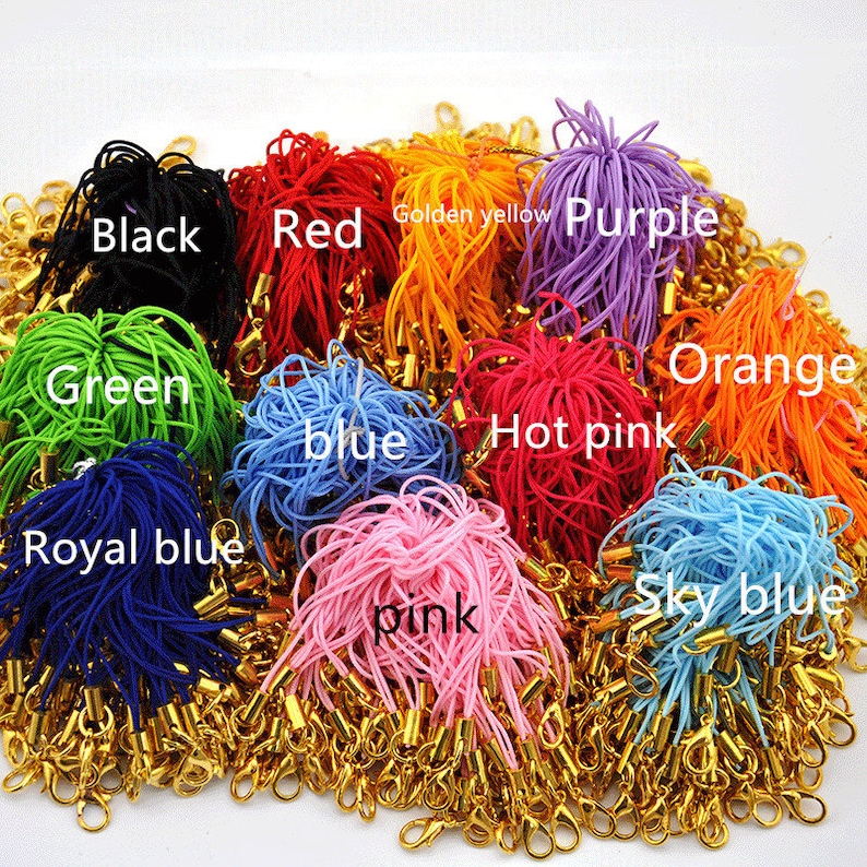 May include: Assortment of colorful cords with gold clasps. The cords are in the colors black, red, green, blue, royal blue, pink, hot pink, purple, orange, and sky blue.  Golden yellow is written on the cords.