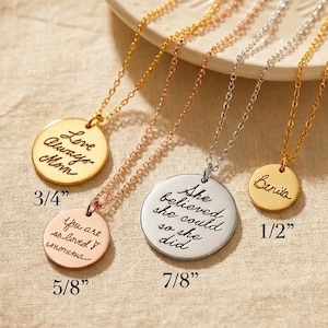 May include: Four round pendant necklaces in gold, rose gold, and silver tones. The pendants feature engraved cursive text: Love Always Mom (3/4 inch), You are so loved momma (5/8 inch), She believed she could so she did (7/8 inch), and Benita (1/2 inch).