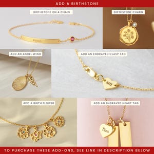 May include: A collection of gold jewelry add-ons including a birthstone on a chain, a birthstone charm, an angel wing charm, an engraved heart clasp tag, birth flower charms with stones, and an engraved heart tag with rectangular pendants.