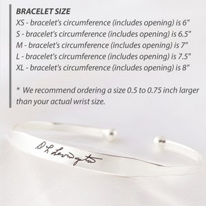 May include: A silver-colored cuff bracelet with a handwritten signature engraved on the front. The image includes a size chart listing circumferences from 6 inches for XS to 8 inches for XL, and a recommendation to order 0.5 to 0.75 inches larger.