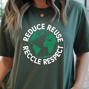 May include: A dark green t-shirt with the words "REDUCE REUSE RECCLE RESPECT" encircling a green globe. The shirt is a solid color and has short sleeves. The shirt is made of a soft, comfortable material.