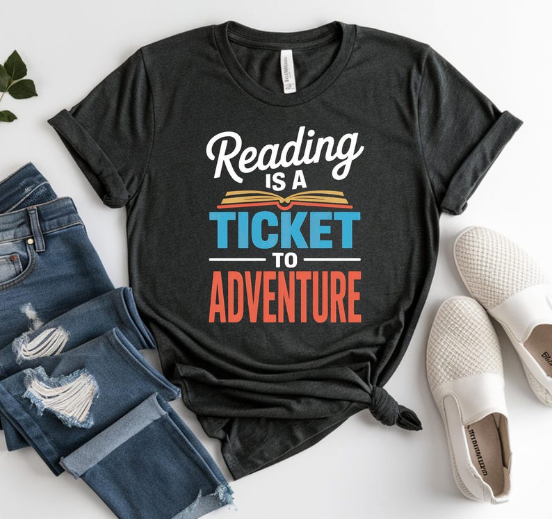 Dark t-shirt with "Reading is a Ticket to Adventure" text and book graphic.