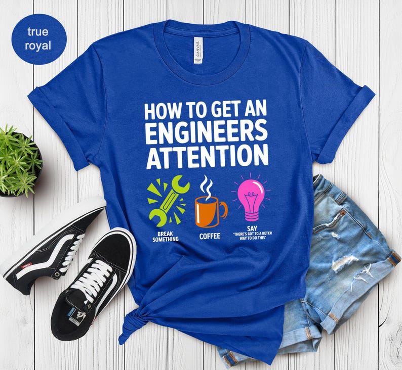 Royal blue t-shirt with "How to Get an Engineer's Attention" text and icons.