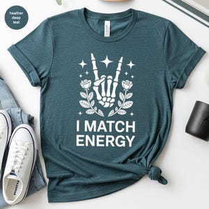I Match Energy Skeleton Hand Shirt, Rock On Gesture with Roses and Stars Tee, Teal Aesthetic Vibe, Goth Alt Gift
I Match Energy, Skeleton
