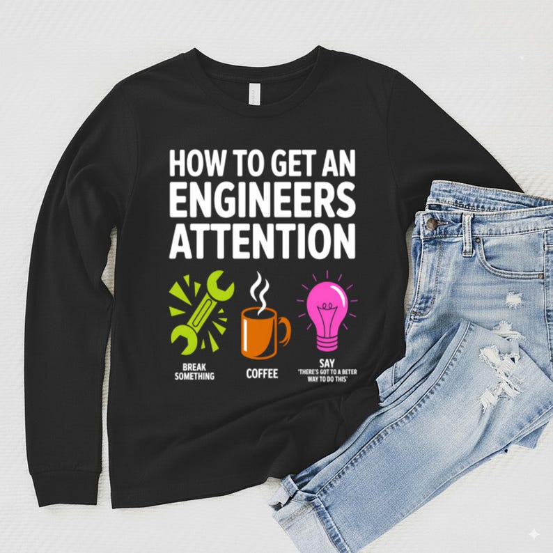 Black long-sleeve shirt with "How to Get an Engineer's Attention" text and icons.