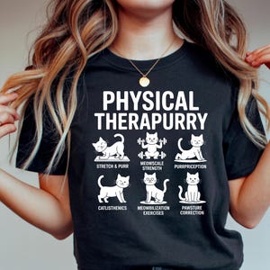 May include: Black t-shirt with the text "PHYSICAL THERAPURRY" in white. The shirt features illustrations of cats performing various exercises, including stretching, weightlifting, and posture correction. A fun and playful design for cat lovers.