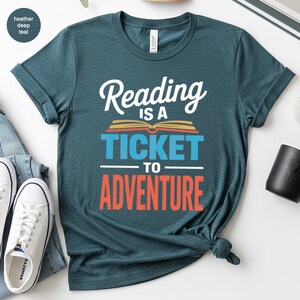Teal t-shirt with "Reading is a ticket to adventure" text.