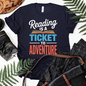 Navy t-shirt with "Reading is a ticket to adventure" text.