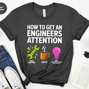 Dark heather t-shirt with graphic about getting engineer attention: break something, coffee, say "there's got to be a better way".