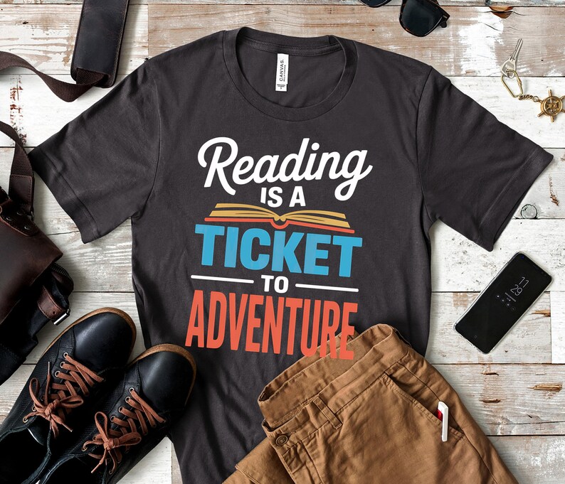 Dark gray t-shirt with "Reading is a ticket to adventure" text.