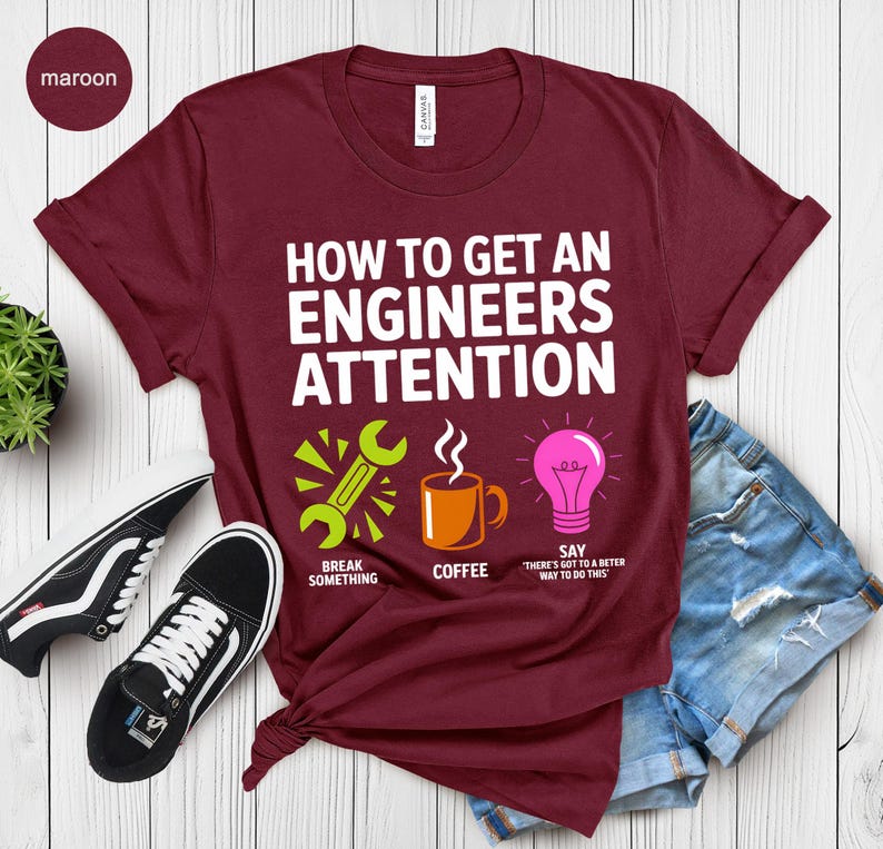 Maroon t-shirt with text "How to Get An Engineers Attention" and icons.