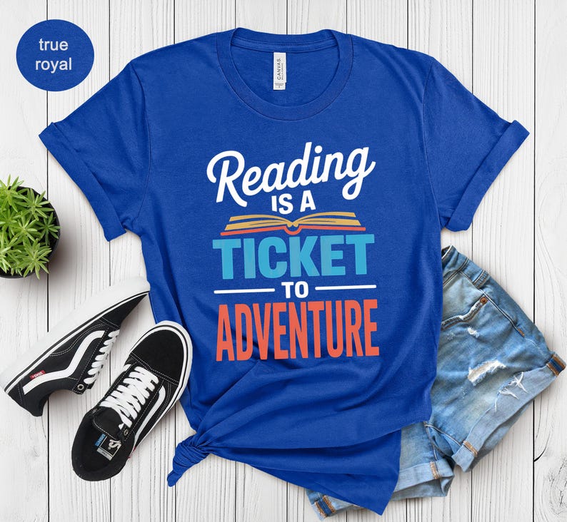 Blue t-shirt with "Reading is a ticket to adventure" graphic.