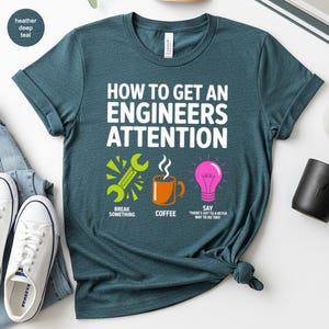 T-shirt with text "How to get an engineer's attention" and icons.