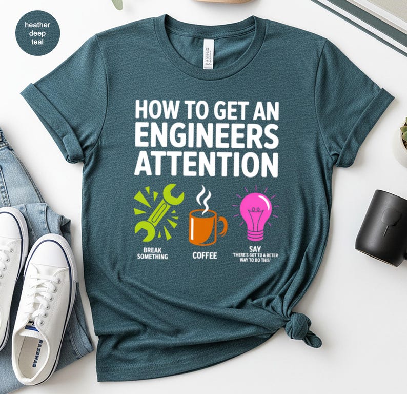 T-shirt with text "How to get an engineer's attention" and icons.