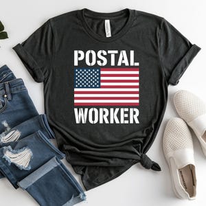 May include: A white ceramic mug with a black handle and the text "But First, Coffee" in a black, handwritten-style font. The mug is on a white surface.