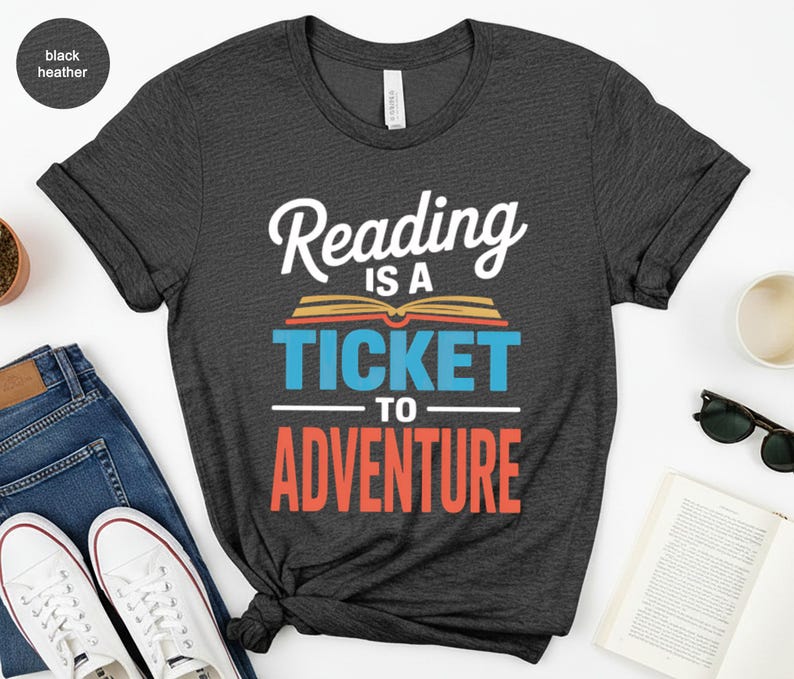 Black t-shirt with "Reading Is A Ticket To Adventure" text.