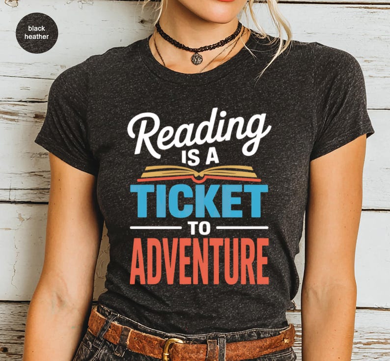 Dark heather t-shirt with "Reading is a ticket to adventure" text design.