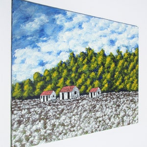 May include: A painting of a rural landscape with three white houses with red roofs in a field of white flowers. The houses are set against a backdrop of green trees and a blue sky with white clouds.