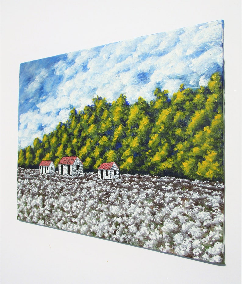 May include: A painting of a rural landscape with three white houses with red roofs in a field of white cotton. The houses are in front of a line of green trees with yellow leaves. The sky is blue with white clouds.