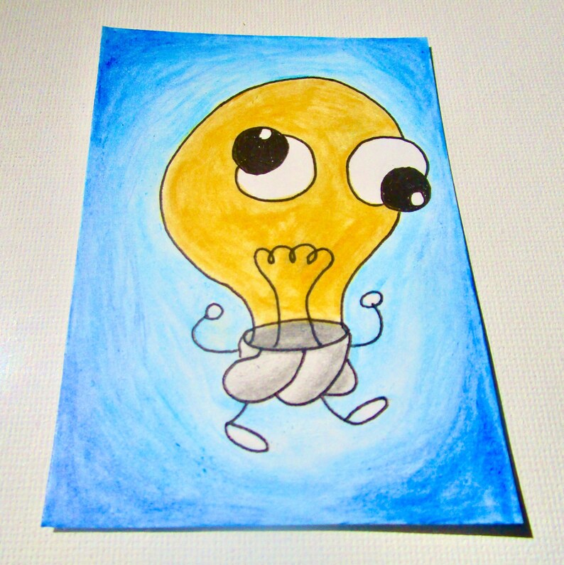 May include: A cartoon illustration of a yellow lightbulb character with big eyes and a surprised expression. The lightbulb has arms and legs, set against a blue gradient background. The artwork is on a rectangular piece of paper.