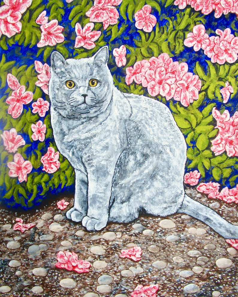 May include: A painting of a solid gray cat with yellow eyes sitting on a pebble-covered ground. The background features a dense green bush filled with vibrant pink flowers, with several fallen pink petals scattered across the ground.
