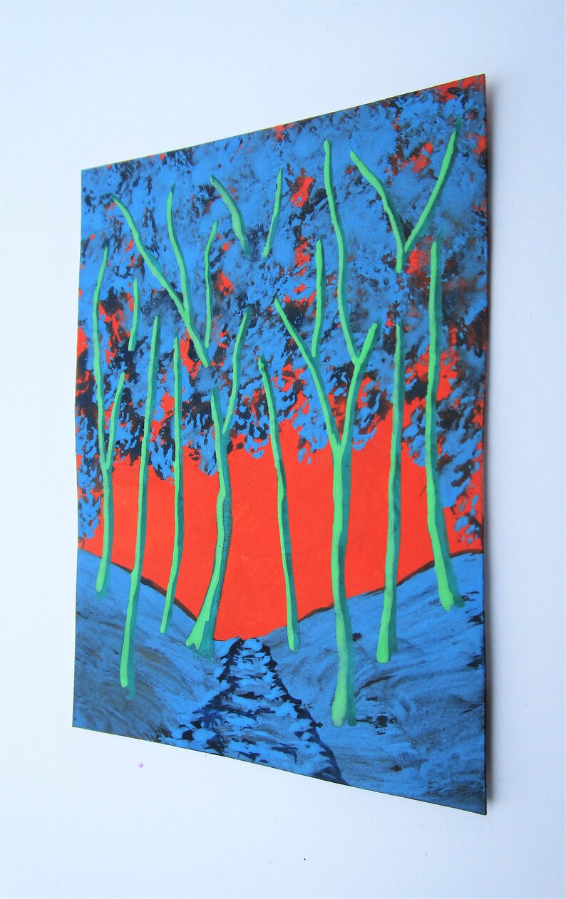May include: A painting depicting a forest scene with tall, green trees against a bright orange sky. The trees are painted in a stylised way, with thick, dark blue trunks and branches. The sky is a vibrant orange, with hints of red and yellow. The ground is covered in a dark blue and black paint, suggesting a forest floor.