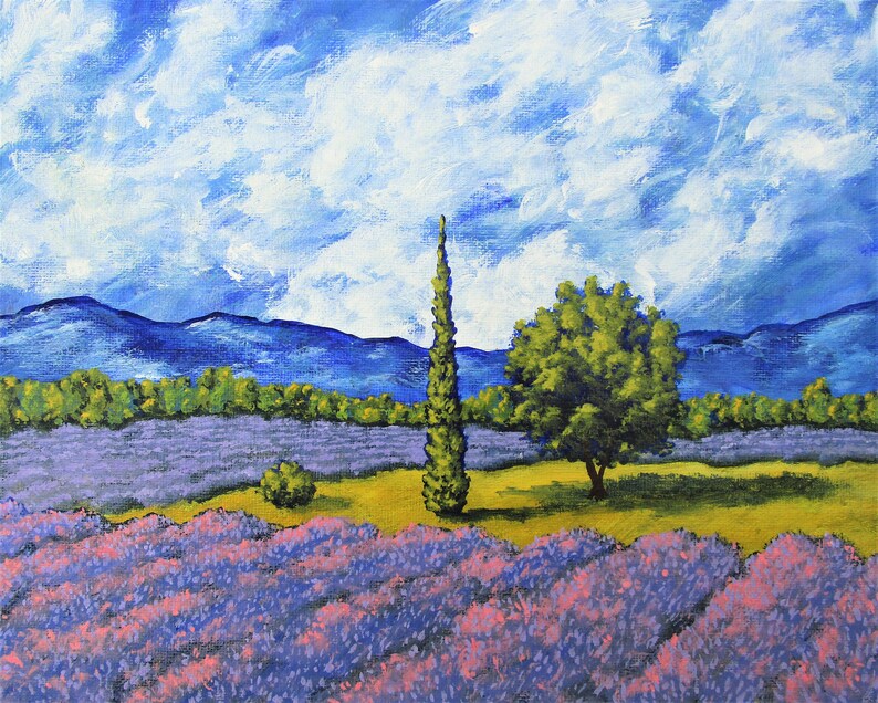 May include: An acrylic painting of a lavender field under a cloudy blue sky. The foreground features rows of purple lavender with pink highlights. A tall, slender green tree stands beside a rounder green tree. Mountains are visible in the background.